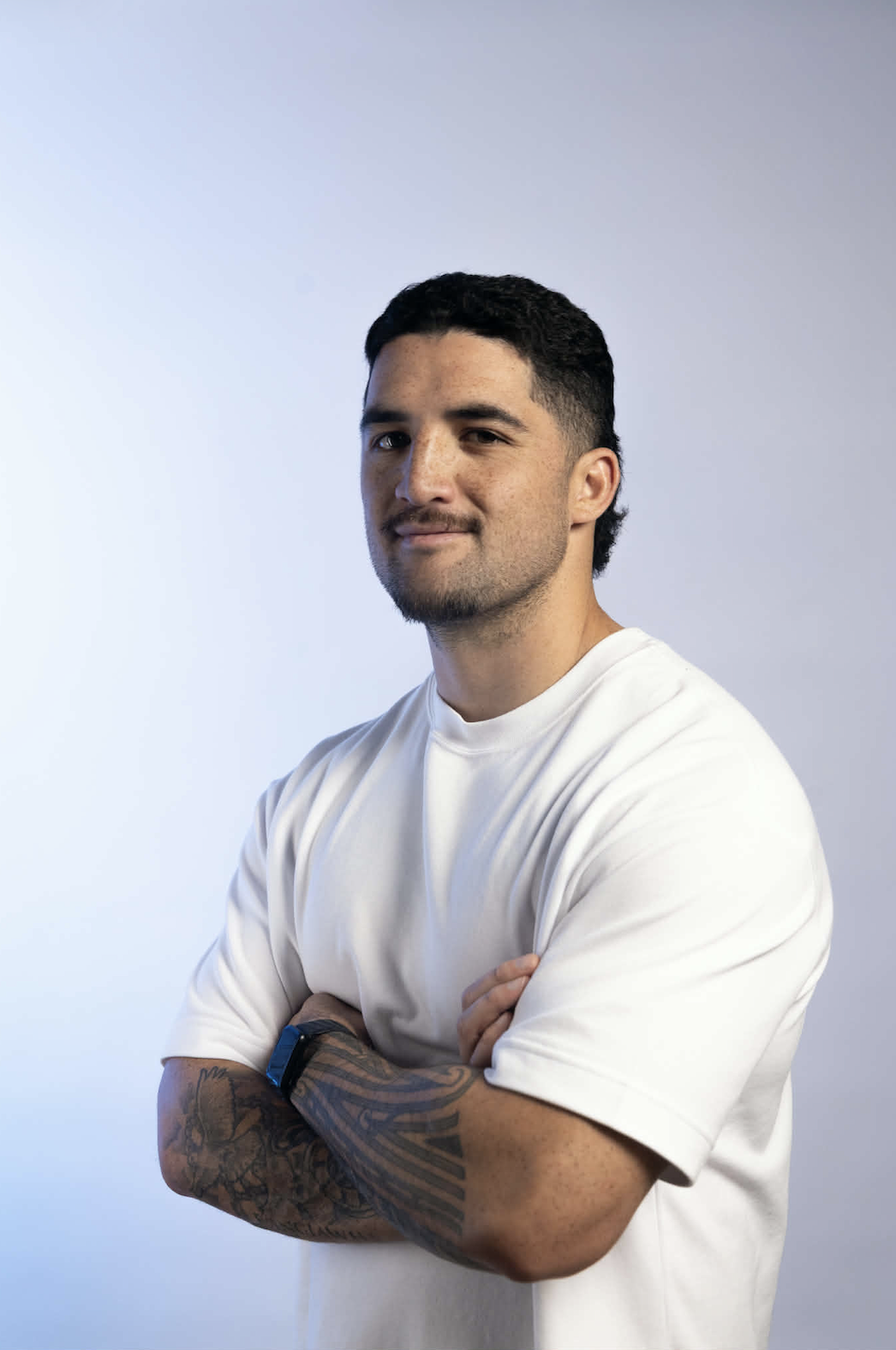 Wikiriwhi Rangiawha, founder of Taff Media, smiling with arms crossed in a white t-shirt